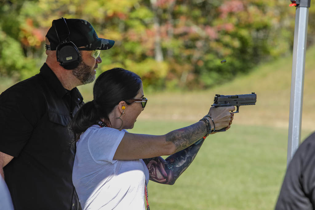 woman shooting a smith & wesson at the celebrity shootout